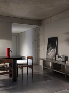 A well-lit, modern room with a dining table and chairs, surrounded by clean lines and minimalistic decoration