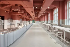A spacious modern restaurant interior with several tables and chairs, well-lit and inviting, with a focus on functionality and comfort