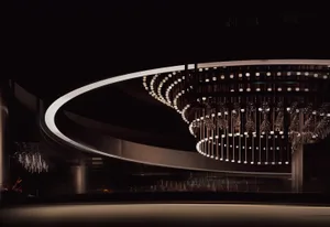 A dimly lit dining space with an ornate chandelier, surrounded by sophisticated decor and artificial lighting