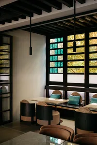 An inviting restaurant with wooden tables and chairs in various styles and sizes, creating a cozy atmosphere for dining and socializing