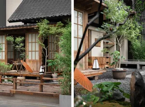 Serene Asian-style house with wooden elements, tiled roof, and potted plants outside
