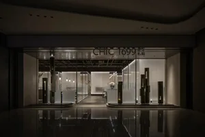 A well-lit modern commercial space with a large glass window, potted plants, and a clean atmosphere