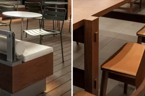 A restaurant with a wooden dining table and chairs, and a modern kitchen with a wooden island countertop