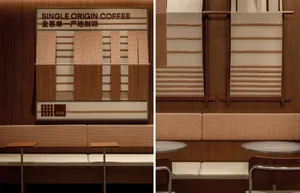 Comfortable cafe interior with couches, tables, chairs, and benches, featuring a coffee bar with information displays