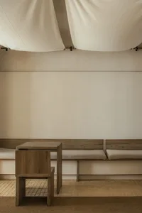 Empty living area with wooden benches and tables, calm and inviting atmosphere
