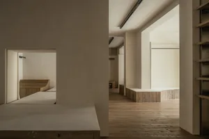Empty room with wooden floors and walls, showcasing clean lines and minimalist aesthetic
