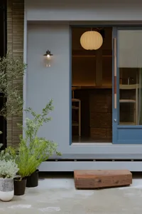 Cozy kitchen dining area with a sink, dining table, chairs, and a potted plant