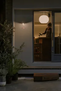 Cozy kitchen with a dining table, chairs, and a wine glass, surrounded by warm and inviting atmosphere
