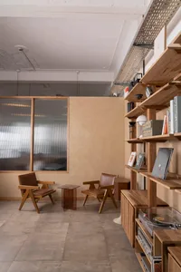 Cozy reading space with two chairs, a small table, and three books, set in a warm and inviting atmosphere