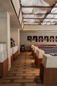 A spacious restaurant and hotel lobby with multiple tables, chairs, and couches arranged in a comfortable and inviting atmosphere