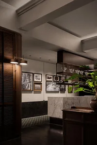 Elegant restaurant interior with marble countertop, wooden accents, and natural light from a large window