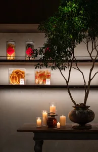 A dining area with a table set with candles and jars of food, creating a warm and inviting atmosphere