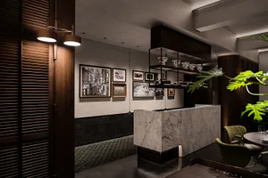 Modern restaurant interior with marble countertop, decorative items, and warm lighting