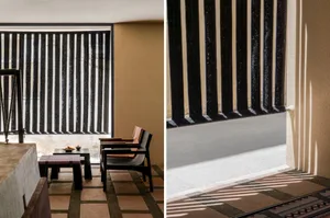 A well-lit interior living area with black and white striped blinds, featuring two dining settings with chairs and tables