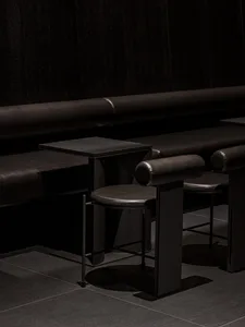 Cozy cafe interior with brown leather benches, wooden tables, and chairs, creating a warm and inviting atmosphere