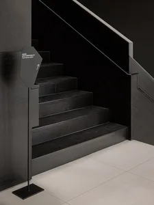 A well-lit stairwell with a wooden staircase, creating a sense of depth and dimension in a functional yet inviting environment