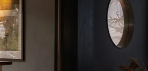 A dark hallway with two mirrors on the walls above a doorway, creating a sense of mystery
