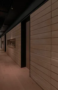 A plain hallway with cement block walls, two doors, and a focus on functionality
