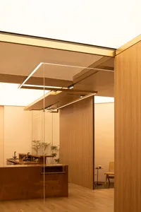 Bathroom with wooden walls and floors, featuring two sinks and a warm inviting ambiance