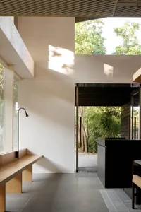 Modern kitchen with a countertop, bench seating, chairs, sink, and dining table, featuring a comfortable and inviting atmosphere