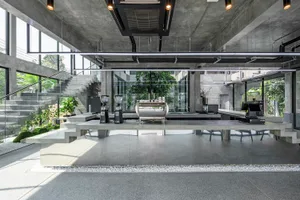 Industrial kitchen with modern appliances, concrete floors, and walls, and a functional yet stylish atmosphere