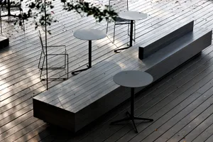 A patio area with multiple tables and chairs, creating a comfortable seating space for outdoor dining and socializing