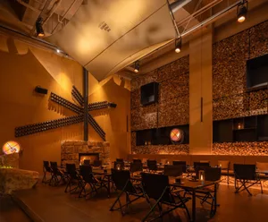 Cozy modern dining area with a large table, chairs, and a fireplace
