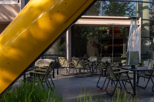 An inviting outdoor dining area with various chairs and tables, perfect for socializing and enjoying meals