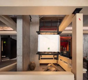 Warm and inviting room with wooden walls and floors, featuring two large vases and natural elements