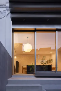 Well-lit interior space with a dining area, potted plants, and a comfortable atmosphere
