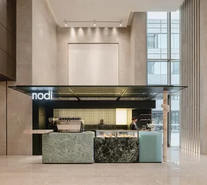 A modern cafe with a counter, couches, and a dining table, featuring marble and wood elements, natural light, and a warm atmosphere