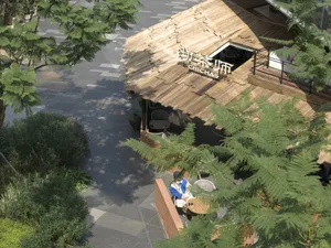 An Asian restaurant with a wooden roof and patio area, featuring dining tables and chairs, and a person enjoying a meal in a relaxed outdoor setting