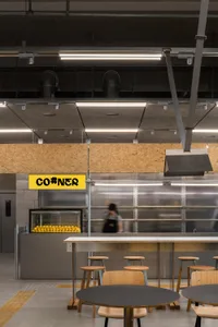 Inviting restaurant kitchen with a counter and chairs, bottles, and a focus on functionality and convenience