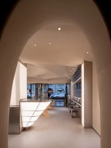 Spacious interior space with white walls, chairs, and dining tables, inviting atmosphere