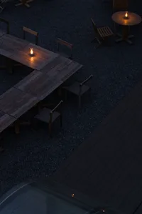 Cozy outdoor dining area with a wooden table and chairs in a rustic setting