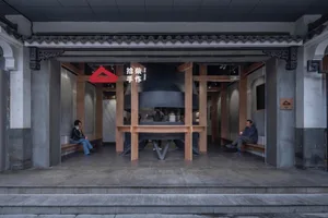 A modern Asian restaurant with a large dining table, chairs, and several people enjoying their meals in a stylish and inviting atmosphere