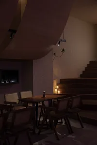 A well-lit dining area with a wooden table surrounded by multiple chairs, creating a cozy atmosphere for guests to enjoy their meals