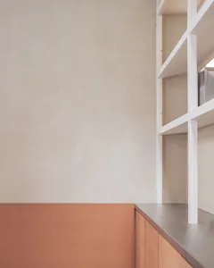 A warm and inviting kitchen scene with a wooden countertop, wooden cabinet, and two books placed on the countertop
