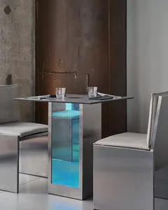 Modern dining area with a glass centerpiece, metal chairs, and a contemporary ambiance