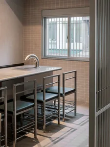 Empty modern kitchen with a large window, a sink, and a dining table with four chairs