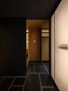 Wooden hallway with two doors, warm and cozy atmosphere, wooden walls and floors