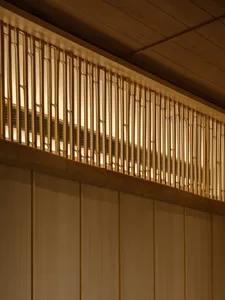 Warm and inviting interior space with wooden walls and ceiling, featuring two large wooden beams on the wall
