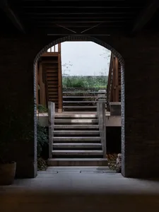 A stone staircase in an old building with natural light illuminating the scene