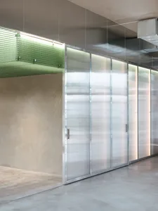 A clean and well-organized hallway with metal walls, multiple doors, and a focus on functionality and efficiency