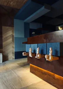 Warm and inviting kitchen space with a wooden countertop, brown finish, and three statues of hands placed on the counter