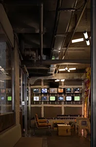Modern interior space with multiple TV screens mounted on the walls, creating a contemporary and engaging atmosphere