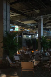 A cozy indoor space with multiple wooden chairs in various positions, creating an inviting atmosphere