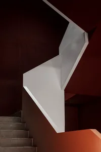 A dark room with a concrete staircase as the focal point, emphasizing its solid and durable appearance