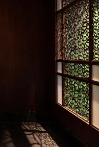 A dark room with a stained glass window, creating a cozy and intimate atmosphere