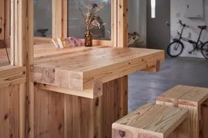 A real kitchen photo with a wooden countertop, bottles, and a bike leaning against the wall, conveying a cozy and functional atmosphere